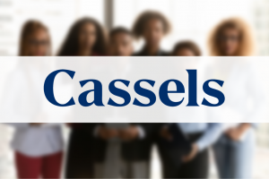 Cassels Brock and Blackwell LLP logo on top of blurred image of a group portrait of sincere young african american employees managers posing in modern workplace, successful motivated mixed race teammates in formal wear looking at camera, corporate career concept.