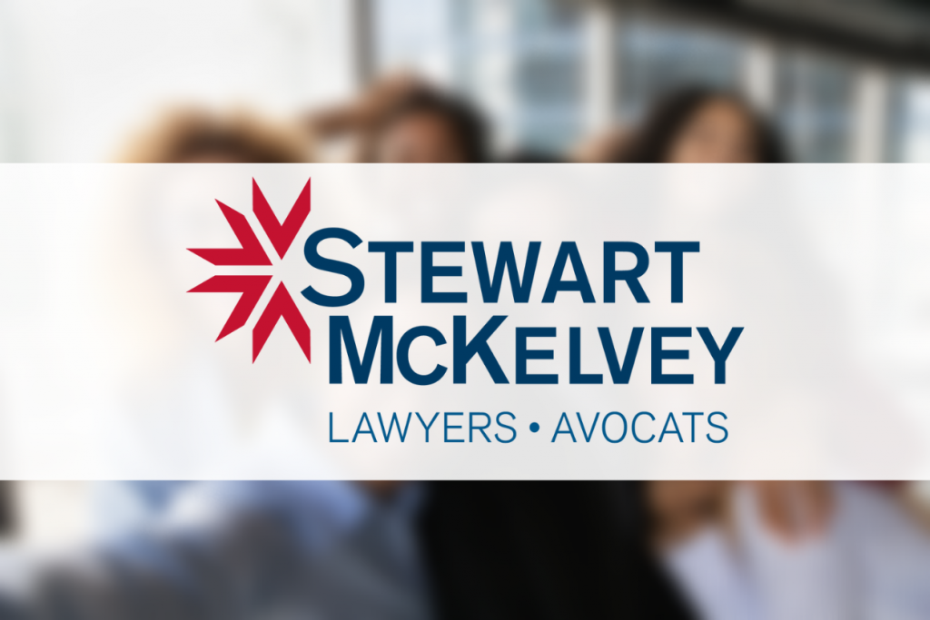 Stewart McKelvey logo on top of a blurred image of a close up portrait of overjoyed young multiracial black employees team have fun posing for selfie on smartphone in office together.